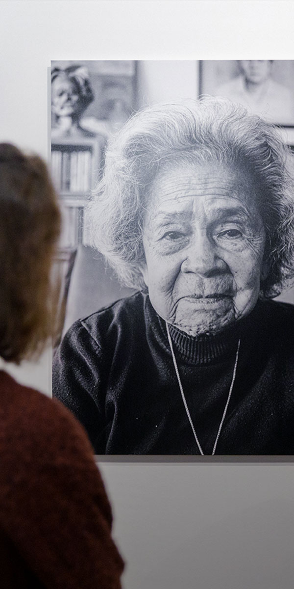Een bezoeker bij een groot zwart-witportret in Dossier Indië