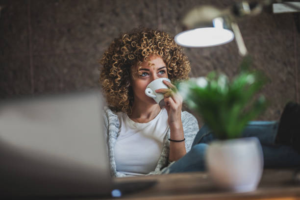 young female businesswoman  drinking coffee and working at office