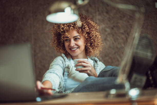 young female businesswoman  drinking coffee and working at office