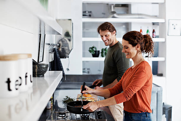 Shot of a smiling mature couple cooking together in their kitchen